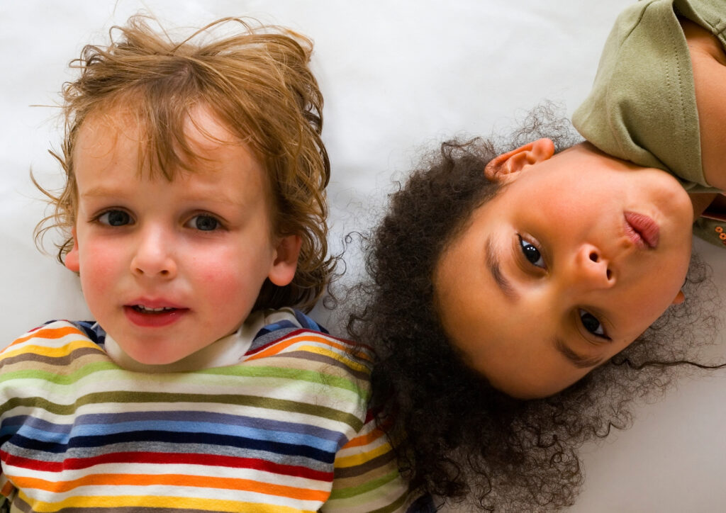 The photo shows 2 children in the toodler period.