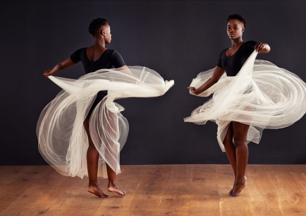 This photo has a woman dancing with tulle.