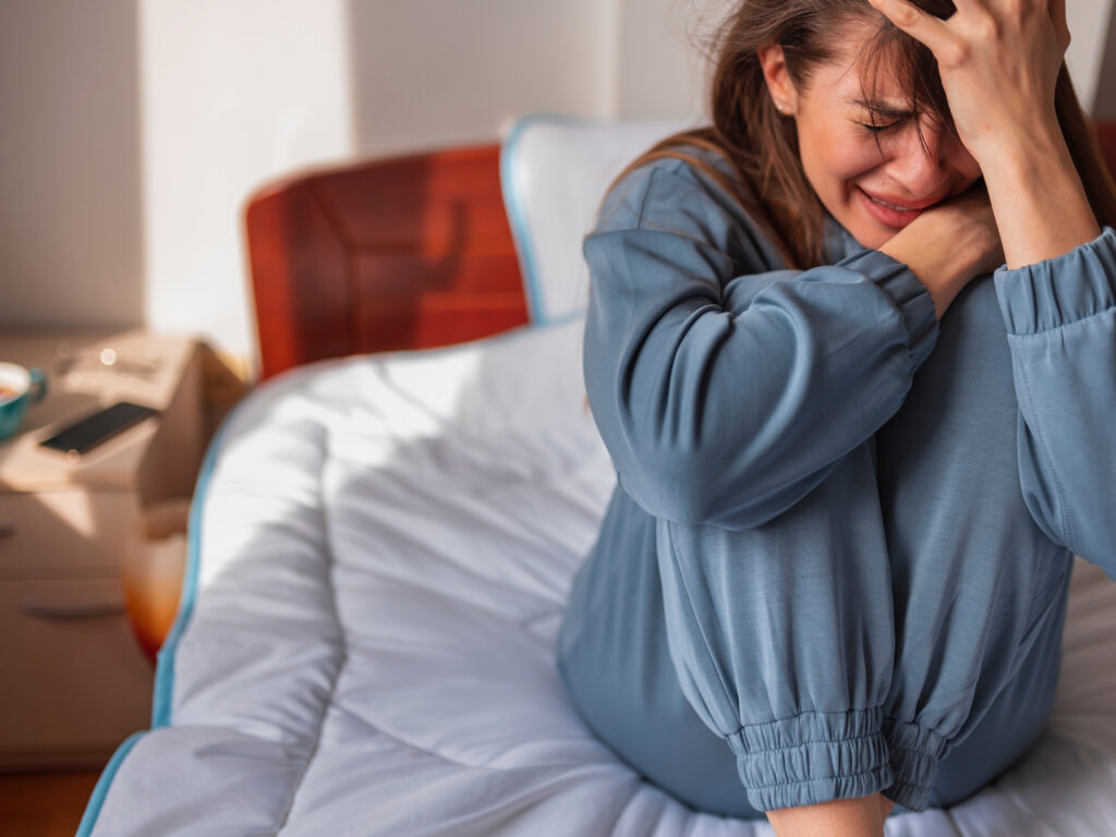 This photo is used to represent a woman a woman with an anxious attachment to her partner. The woman is crying in the photo. 